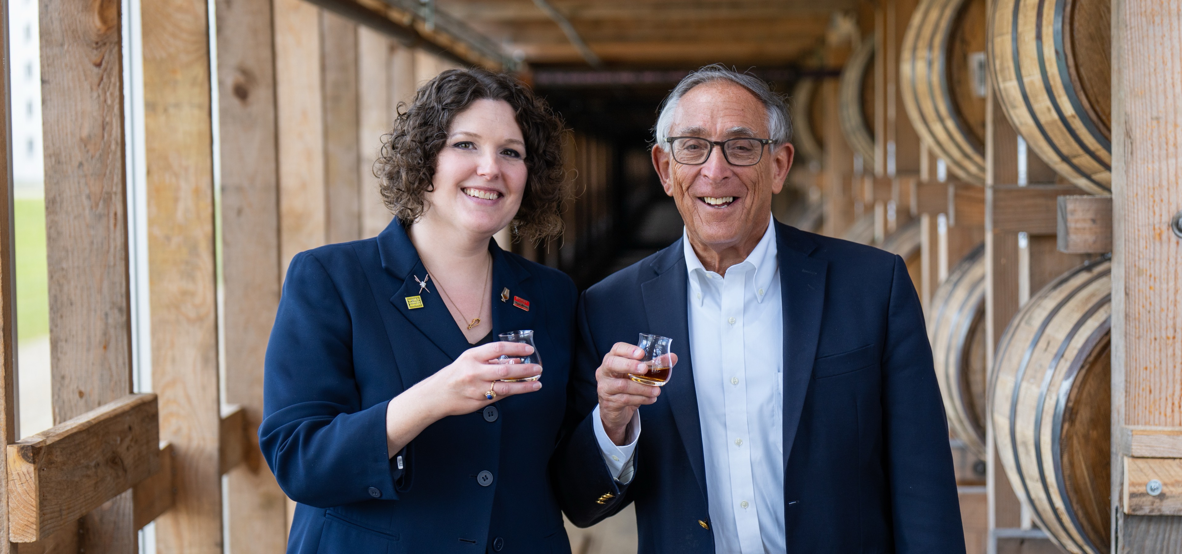 Whisky Magazine writer and Heaven Hill chairman toasting in a rickhouse